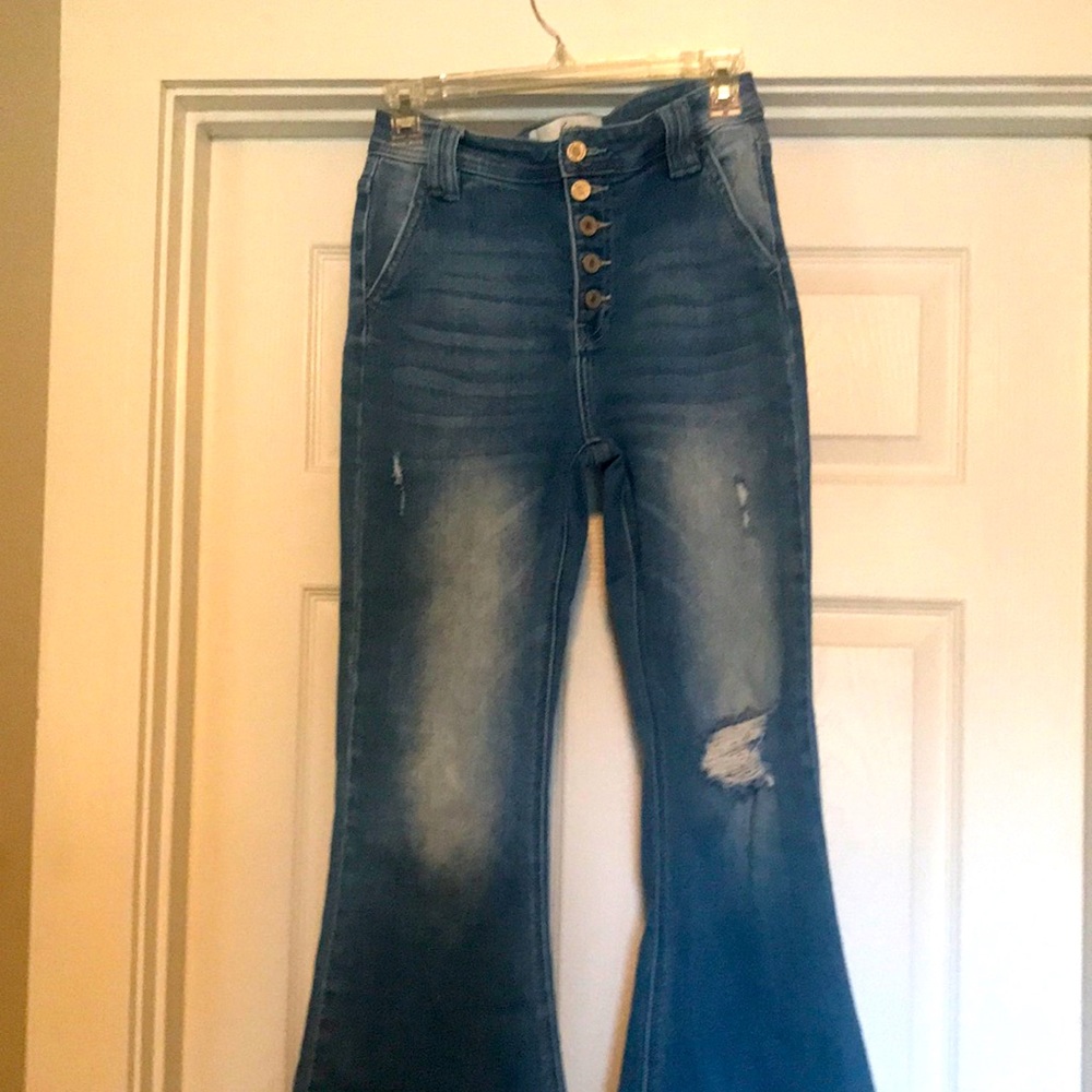 KanCan wide flare leg distressed jeans.